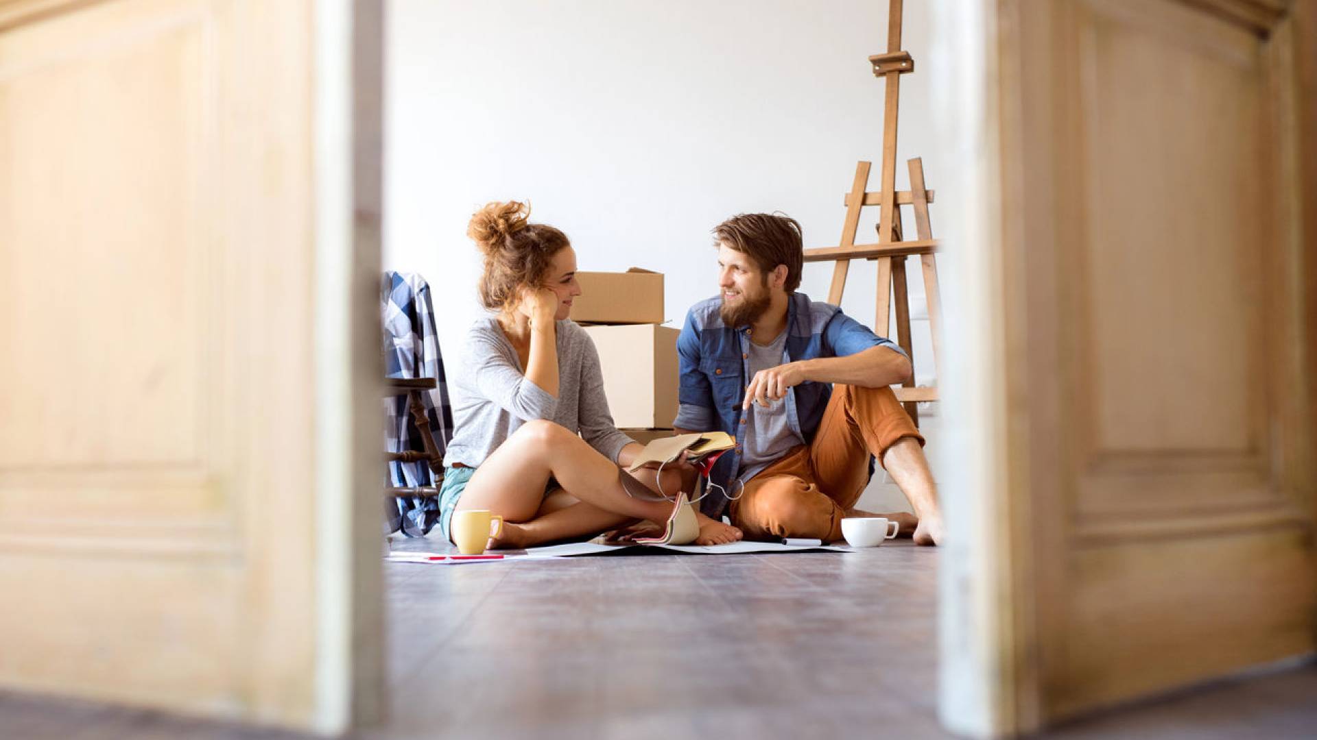 Young couple moving in new house, resting.